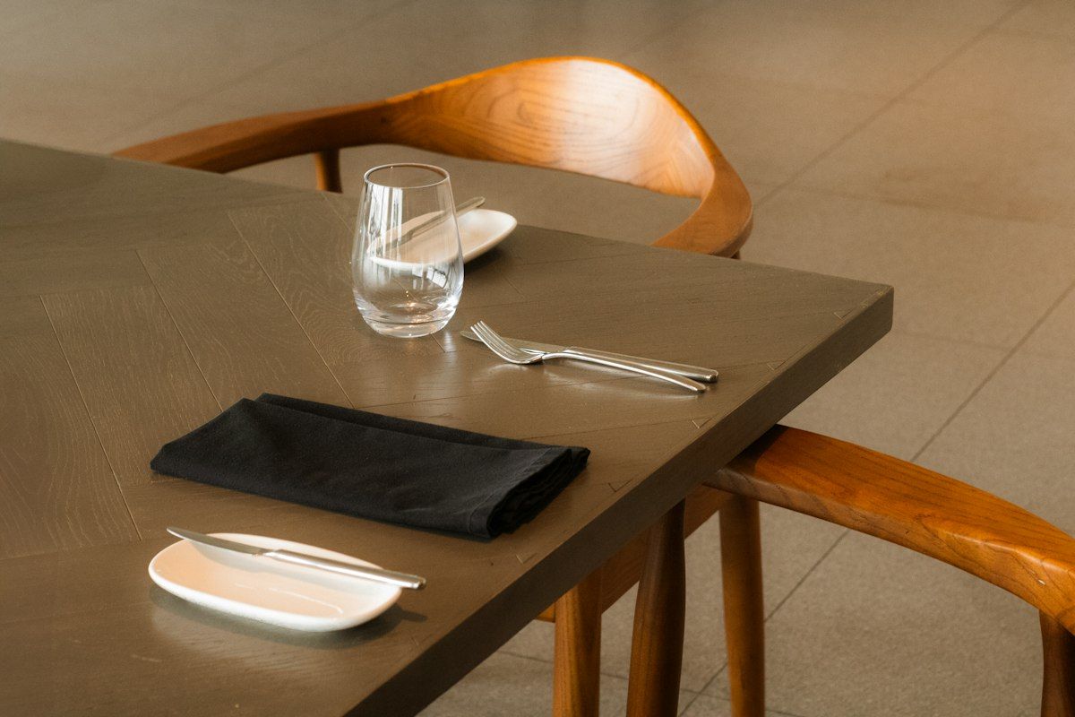 A minimal place setting on a restaurant table