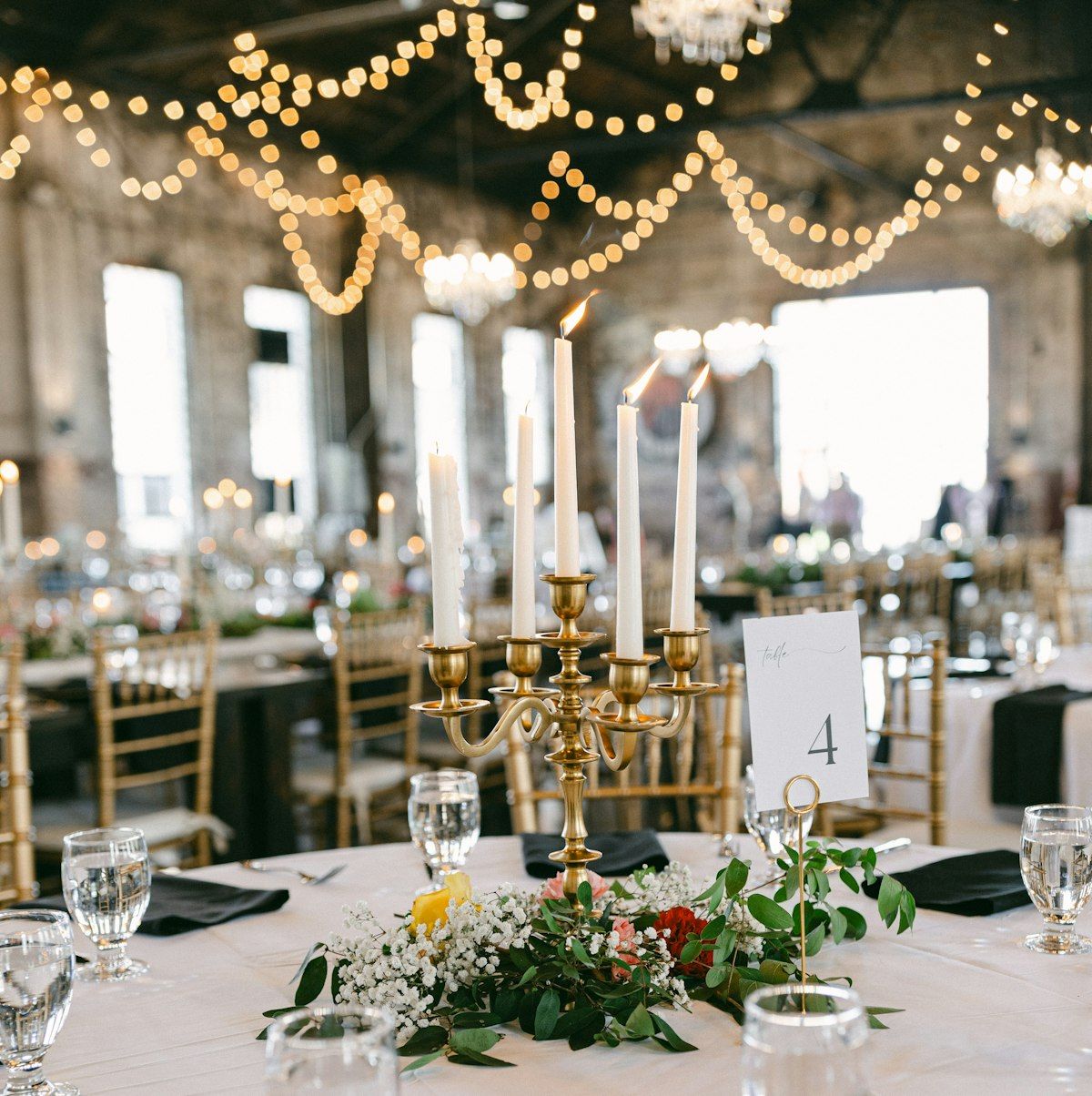 A wedding reception laid out under string lights