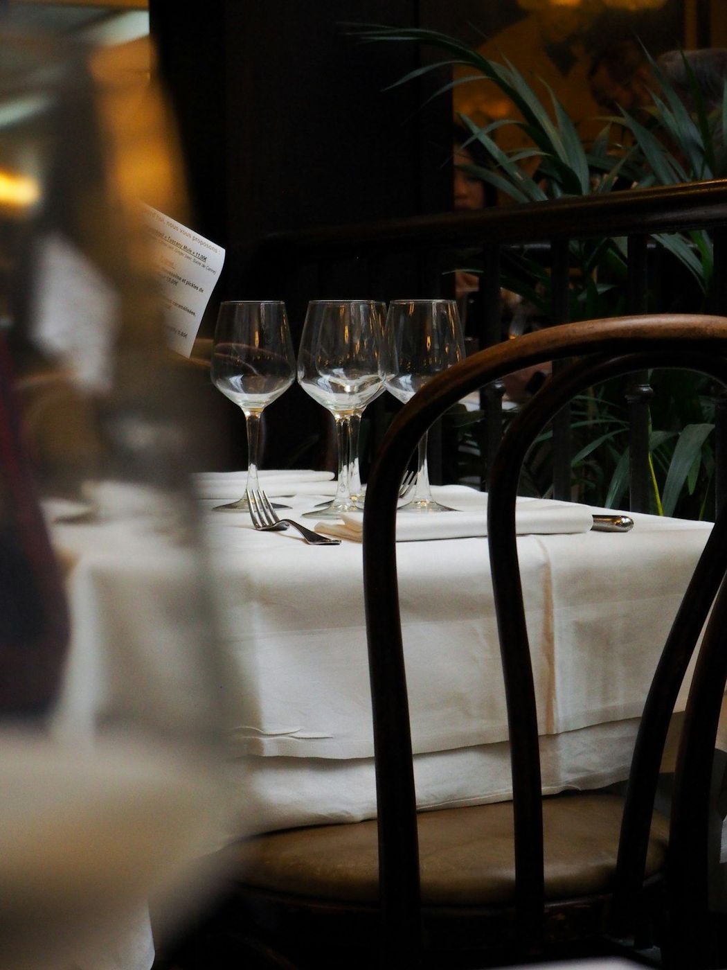 A laid table in a restaurant, glassware and white linen